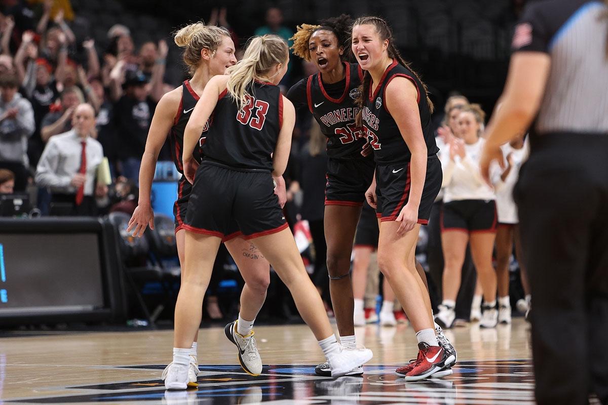 Dasia Thornton celebrates with teammates in the game against Christopher Newport.